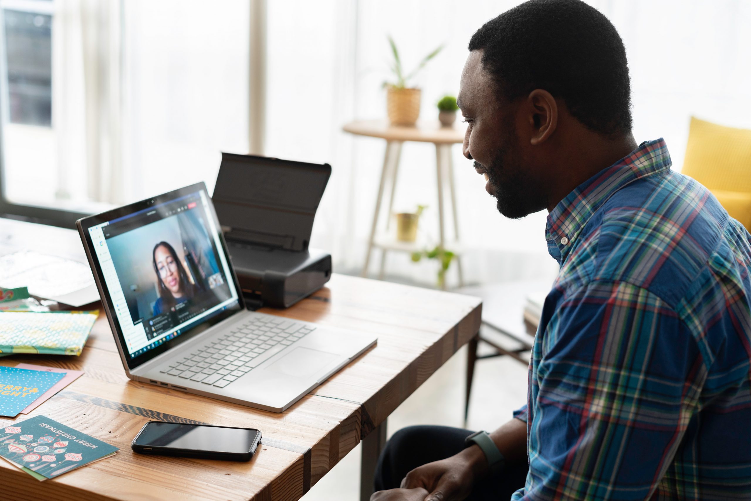 Man holding cross-cultural virtual meeting on Zoom