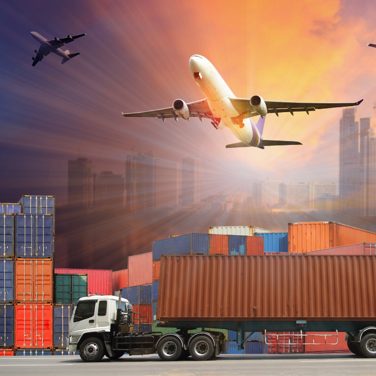 Several cargo planes take off over a stack of shipping containers