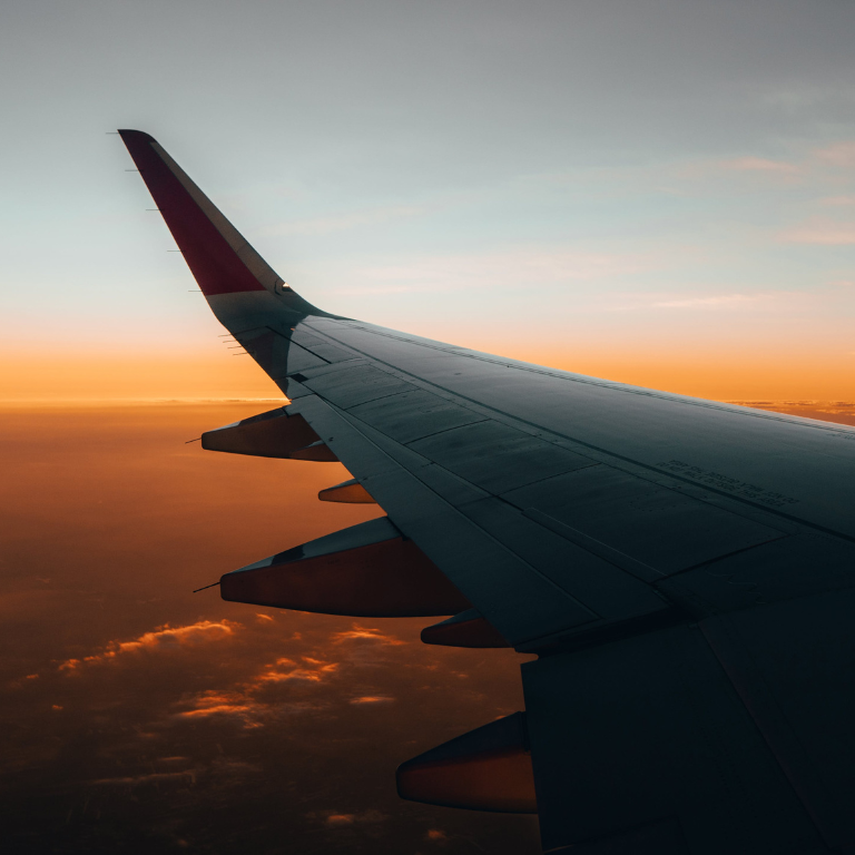 looking out the window of an airplane at the wing